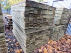 STACK OF TREATED FEATHER EDGE TIMBER: 2 X LARGE PACKS @ 1.8M LENGTH 100MM WIDTH APPROX.