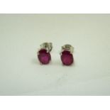 Pair of oval ruby silver stud earrings
