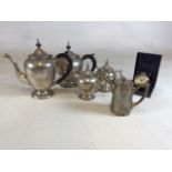 A silver plated tea and coffee set together with a travel clock by Dalvey, Scotland