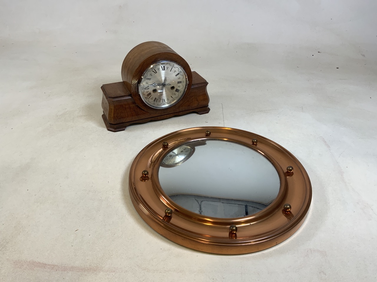 A twentieth century walnut cased mantle clock together with a reproduction convex metal mirror 42cm