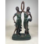 A Resin statue of a pair of ladies on plinth. W:34cm x D:15cm x H:59cm