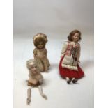 Three dolls. One in National dress ,( possibly Polish) an early celluloid doll and a pin head doll