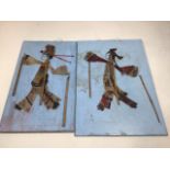 A pair of celluloid stick puppets. Largest 34cm high