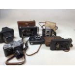 A collection of cameras including a Prinzflex500e, a Zenith, a Rajar No6, a Brownie reflex and a