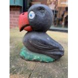 A reconstituted stone hand painted puffin garden ornament. H:35cm