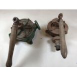 Two vintage water pumps with wooden handles