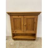 A small pine wall cupboard with interior and lower shelf. W:70cm x H:82cm