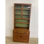 A G plan mid century two piece wall cupboard with glazed bookcase with two internal shelves above