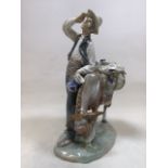 A Lladro figurine of a donkey and pedlars W:20cm x H:27cm