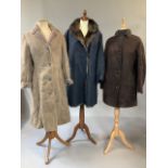 Three ladies coats. Two sheepskin and a faux fur lined coat. Camel coloured full length coat size