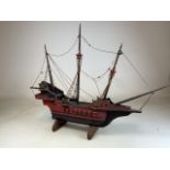 A model of a pirate ship on stand.