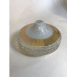A circular mid century glass ceiling light shade with embossed and painted abstract design