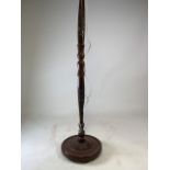 A mahogany Black Forest style floor lamp with carvel detailing of a town landscape. H:150cm (