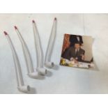 Four Royal Summer ball clay pipes with a photograph of Prince Charles smoking a similar example.