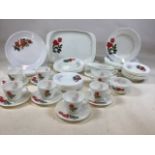 A Pyrex dinner set includes dinner plates, tray, tea plates, cups and saucers, bowls, gravy boat and