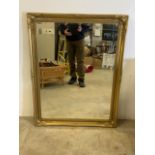 A large gilt framed bevelled mirror. W:90cm x H:116cm