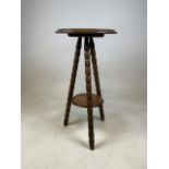 A bobbin turned three legged gypsie table with lower shelf. W:39cm x D:39cm x H:73cm