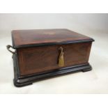 A late 19th early 20th century inlaid rosewood music box with lacquered interior and base and gilt