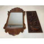 A fret carved wall mirror with gilt inlay also with a carved panel. W:36cm x H:64cm. Panel W:20cm