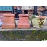 A pair of clay chimney pots with square bases also with a hexagonal terracotta planter. W:33cm x D: