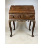 A 19th century ladies writing desk with rosewood interior and two drawers to front. With carved