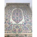 A Kashmiri hand stitched wool chain rug in pastel colours on a cream ground W:119cm x H:172cm