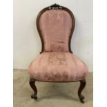 A late 19th early 20th century bedroom chair with Queen Anne style legs on brass and ceramic