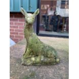 A small reconstituted stone statue of a young deer. H:39cm