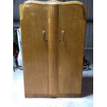 A mid-century Art Deco style maple veneered wardrobe. Two doors and a hanging rail to one side W:
