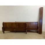 A 20th century sleigh bed with slats.