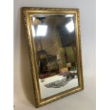 An Aston Martin embossed mirror with bevelled edge and gilt frame. W:50cm x H:78cm