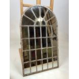 A contemporary arched mirror in distressed metal frame W:36cm x H:60cm