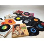 A boxed set of Elvis Presley cases sets together with vinyl 45s including Blondie, ABBA,