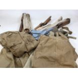 A folding wood and canvas camp bed together a collection of lightweight military issue shorts and