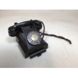 A vintage Bakelite phone with pull out drawer in base.