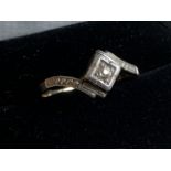 A diamond platinum and unmarked gold ring. Size q.