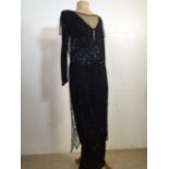 A black beaded tulle over dress with a black under dress. Circa 1930s. Needs some repairs but wear