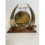 A Large brass gong with horn supports and silver plated mounts on original oak base with gong