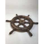 A wooden ships wheel with a brass bearing W:50cm includes handles