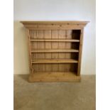 A pine freestanding open bookshelf. With stepped cornice and three adjustable shelves. W:127cm x D: