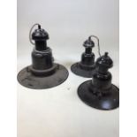 Three black industrial enamel lights. A pair of 26cm shades and a larger shade 36cm