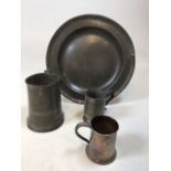 A large pewter plate together with two tankards and one other H:34cm