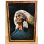 An oil portrait of a Native American Indian in war bonnet. Oil on textured felt in frame. Frame size