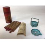 A vintage set of Chinese Fortune sticks and a set of Cloisonne coasters in stand