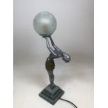 An art deco style figural lamp of skirted lady holding a glass ball H:55cm Overall height
