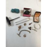 A collection of costume jewellery, a stone, possibly magnetite, a vintage corkscrew and other items