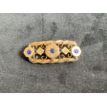 9ct bar brooch inset with blue stones.