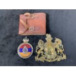 A Royal Army Medical Core white metal and enamel badge also with a brass plaque coat of arms and a