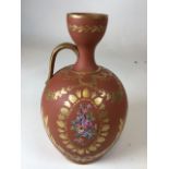 An unglazed highly decorative hand gilded and painted bottle vase. With birds and flowers H:24cm