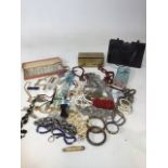 A quantity of costume jewellery toghehter with a vintage tin, glass knife rests and a handbag